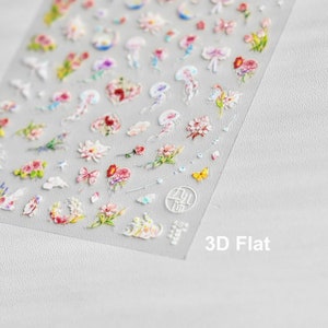 May include: A sheet of clear nail stickers with a variety of 3D floral and jellyfish designs. The stickers are arranged in rows and include butterflies, bows, and other small details. The sheet is labeled "3D Flat".