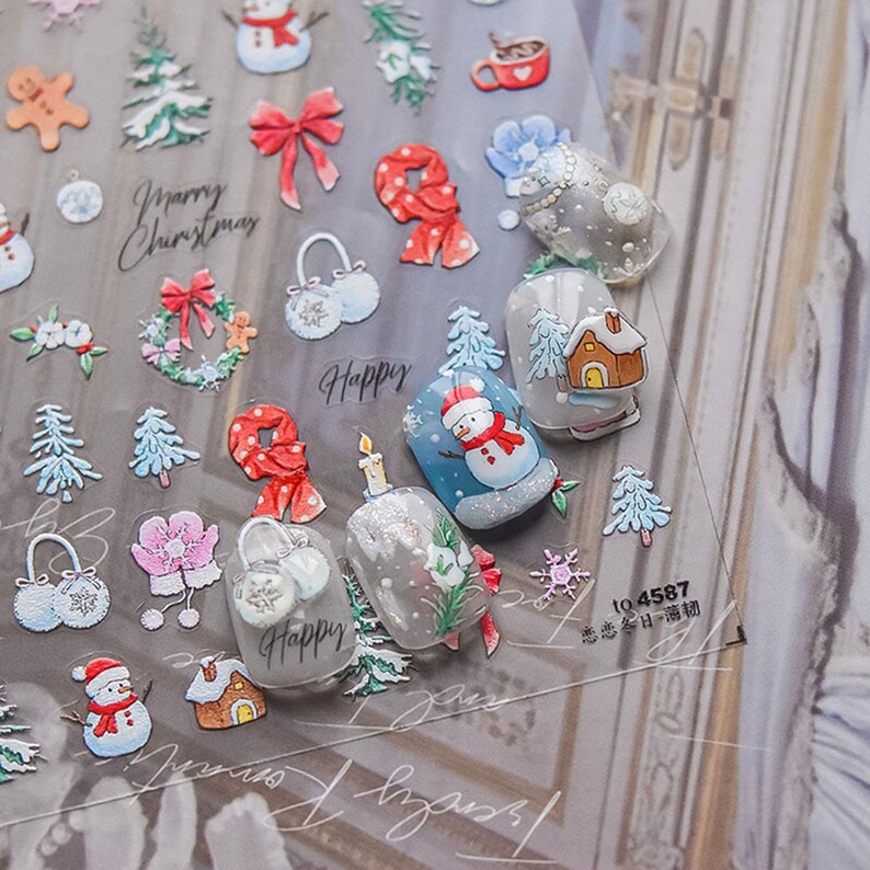 May include: A sheet of clear nail stickers with a Christmas theme. The stickers feature images of snowmen, Christmas trees, presents, candy canes, and other festive designs. The sheet also includes the text "Merry Christmas" and "Happy".