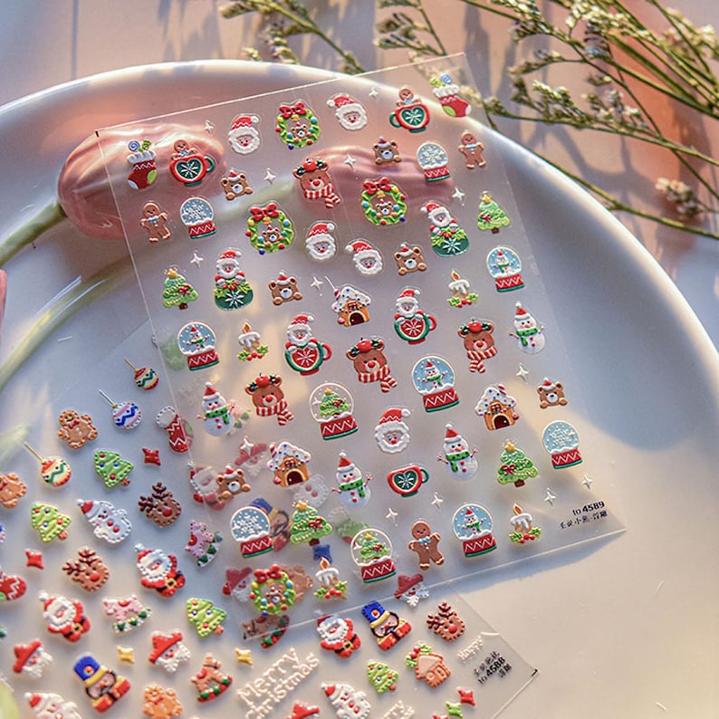 May include: A sheet of clear plastic with a variety of Christmas-themed stickers. The stickers feature images of Santa Claus, snowmen, reindeer, Christmas trees, gingerbread men, and snow globes. The stickers are perfect for adding a festive touch to gifts, cards, or crafts.