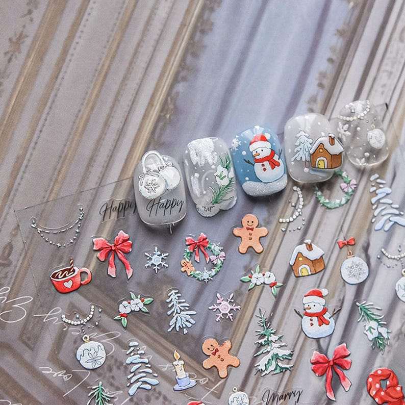 May include: A sheet of clear nail stickers with a variety of winter holiday designs, including snowmen, gingerbread men, Christmas trees, ornaments, and wreaths. The stickers also include the words "Happy" and "Merry".