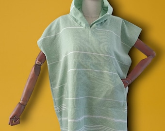May include: A light green hooded towel with white stripes. The towel has a pocket on the side.