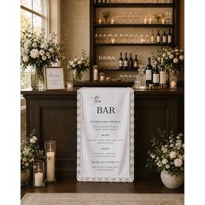May include: A dark wood bar with a white runner featuring the text "The BAR" and a list of drink options. The bar is decorated with floral arrangements, candles, and bottles of wine and liquor. A sign that says "cheers" is also visible.