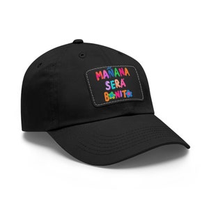 May include: A black baseball cap with a colourful patch that says "mañana será bonito" with a flower graphic.