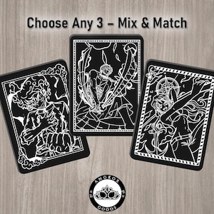May include: Three black rectangular cards with white anime-style illustrations. The cards have detailed character designs. The text "Choose Any 3 - Mix & Match" is at the top. The Angkor Goods logo is at the bottom.