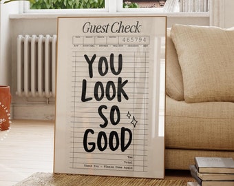 May include: A black and white printable wall art design with the text "Guest Check" and "You Look So Good" on a white background with black lines. The design is inspired by a vintage guest check.