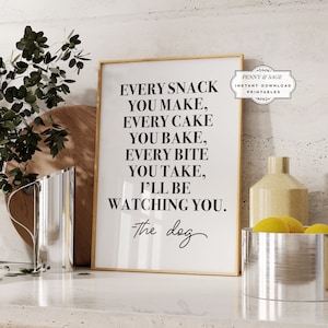 May include: A printable wall art design with a gold frame and white background. The text reads "Every snack you make, every cake you bake, every bite you take, I'll be watching you. -The dog".