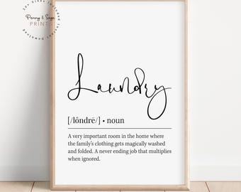 May include: A framed print with the word "Laundry" in elegant cursive script. Below, a definition describes the laundry room's function. The print is in a light wooden frame, suitable for home decor.