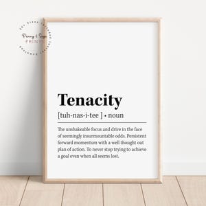 May include: A framed print with the word "Tenacity" in bold black font. The definition of tenacity is provided below the word. The print is in a light wood frame and includes the text "Penny & Sage PRINTS" in a circular design.