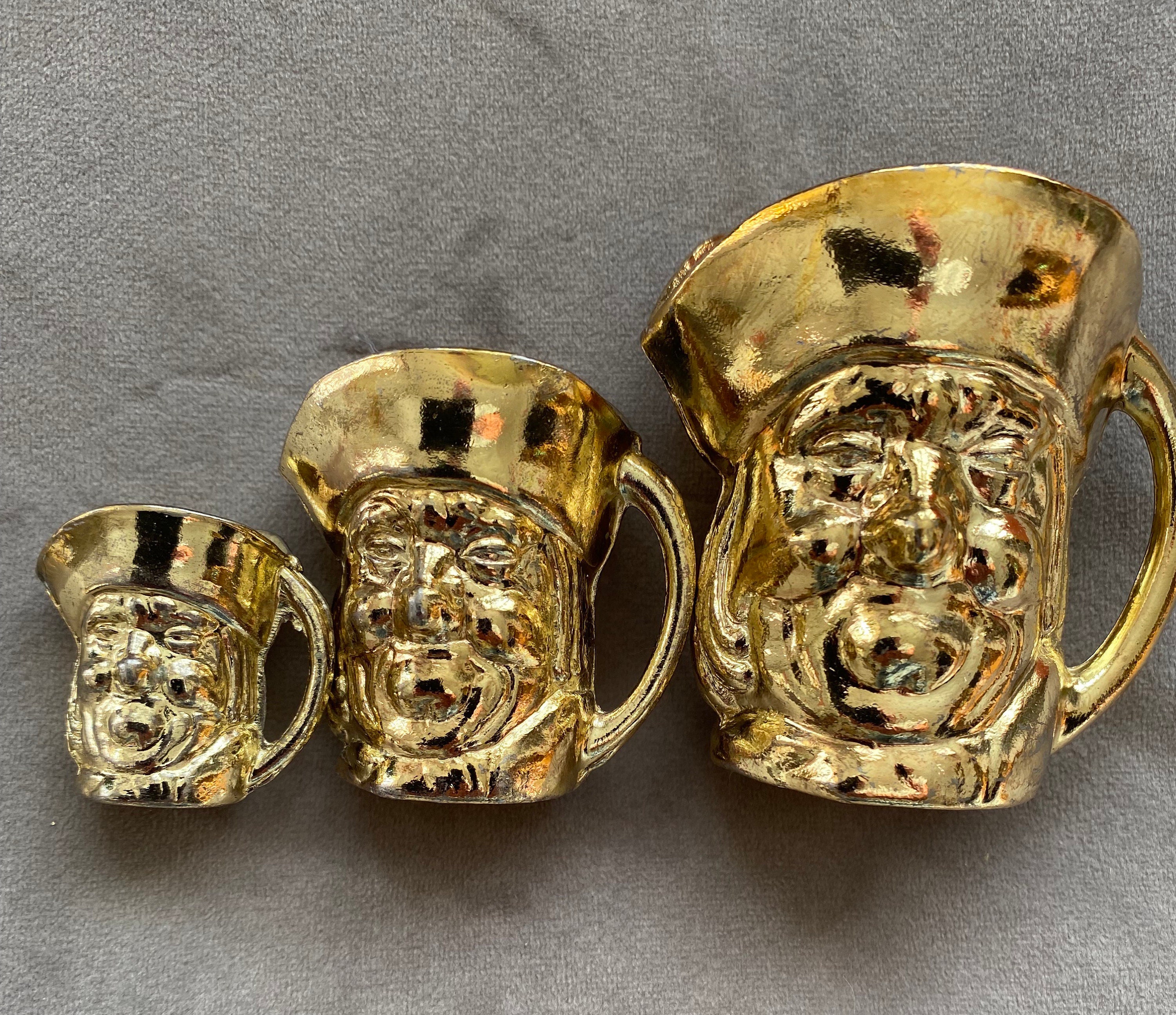 Set of three Brass colour Toby Jugs (129)
