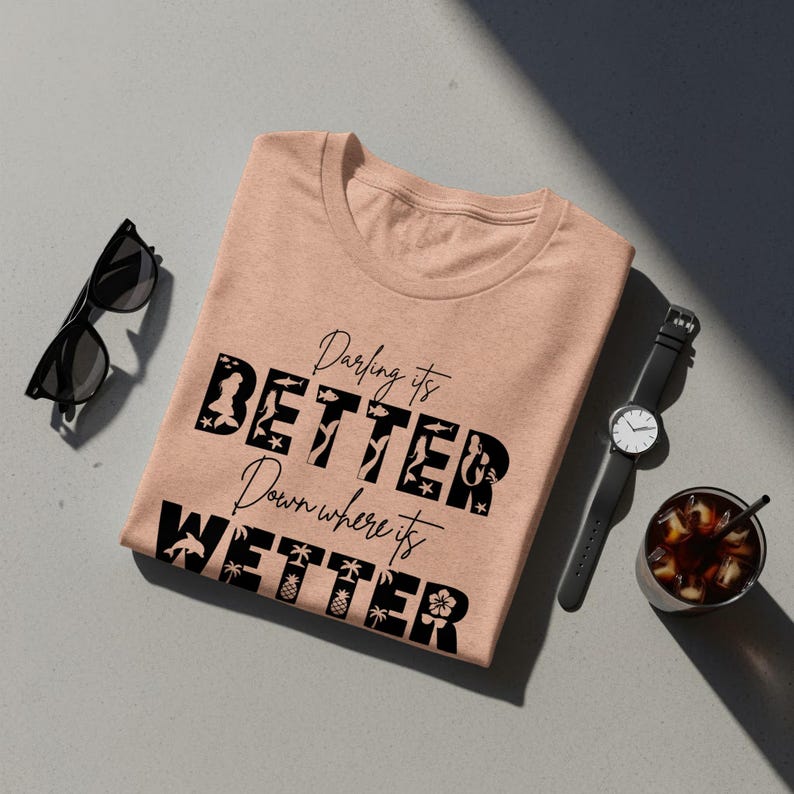 Peach t-shirt with "Darling it's BETTER Down Where it's WETTER" text and beach icons.