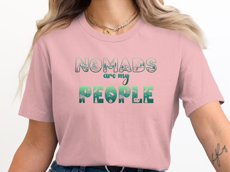 Pink t-shirt with "Nomads are my people" in a gradient green design.