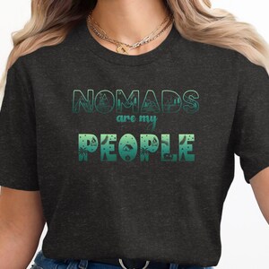 Dark grey t-shirt with "NOMADS are my PEOPLE" in green ombre text.