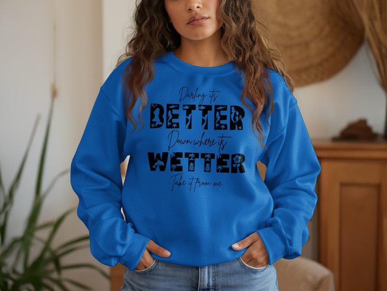Blue sweatshirt with "Darling it's better down where it's wetter" text.