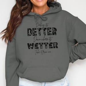 Dark gray hoodie with text "Darling it's better wetter, take it from me".