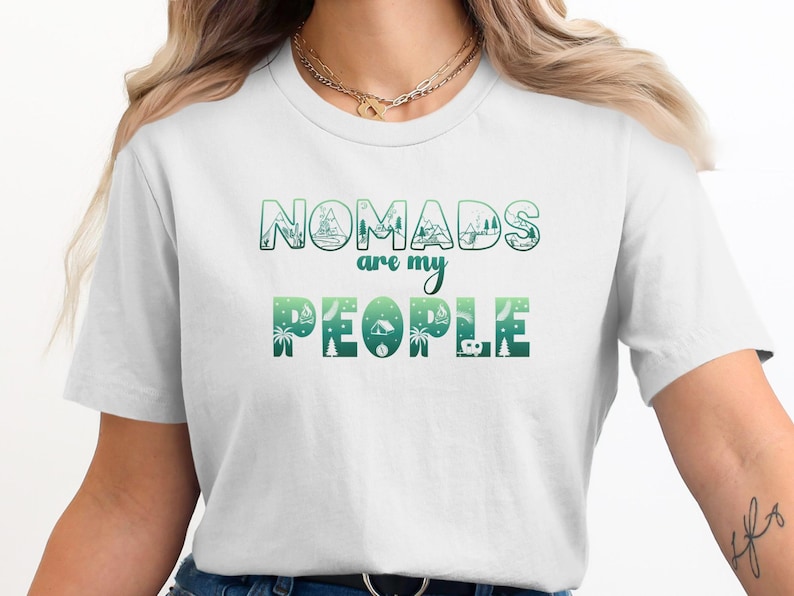 White t-shirt with "Nomads are my people" text and green outdoor graphic.