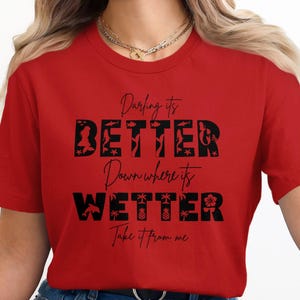 Red t-shirt with black text: Darling it's BETTER Down where it's WETTER Take it from me