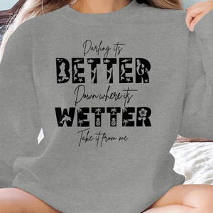 Grey sweatshirt with "Darling it's BETTER Down where its WETTER Take it from me" text.