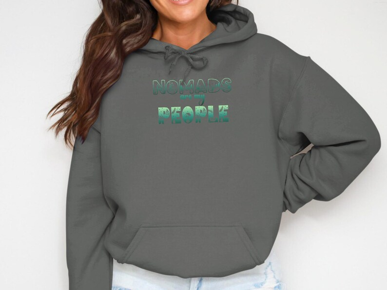 Dark gray hoodie with "Nomads are people" text in green and teal gradient.
