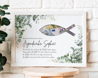 May include: A framed print with a white border, featuring a fish-shaped design made from a Euro banknote. The print includes text and decorative green foliage. The frame rests on a wooden stool against a white brick wall.