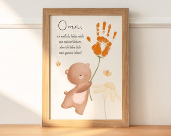 May include: A framed print with a handprint in orange paint, a brown bear holding a flower, and the text "Oma. ich weiß du liebst mich seit meiner Geburt, aber ich liebe dich mein ganzes Leben!"