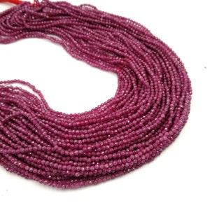 May include: A strand of deep pink ruby beads, each bead is faceted and measures approximately 3mm in diameter. The beads are strung on a thin thread and are ready to be used for jewelry making.