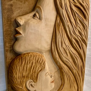 Wood carving with the theme of loving embrace