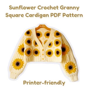 May include: A crocheted cardigan with a sunflower pattern. The cardigan is cream colored with yellow and brown sunflowers. The cardigan has a V-neck and long sleeves. The cardigan is on a hanger. The text "Printer-friendly" is at the bottom of the image.