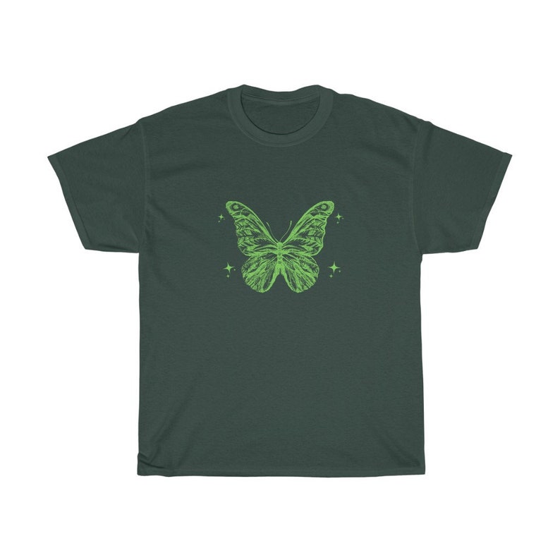 May include: A dark green t-shirt featuring a light green butterfly graphic. The butterfly has a detailed design and is surrounded by small stars.