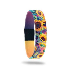 May include: A vibrant sunflower-themed wristband. The band features a repeating pattern of yellow sunflowers with brown centers and green leaves against a colorful background. The interior is purple, with a black closure and yellow and orange accents.
