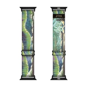 May include: A black and green Apple Watch band with a tie-dye pattern and the text "Live in the Moment" printed on the band.