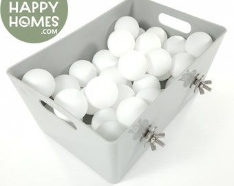 May include: A grey plastic bin filled with white table tennis balls. The bin has two silver metal fasteners on the sides.