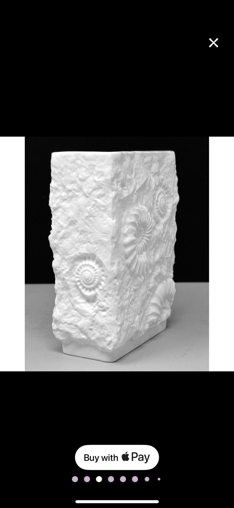 Puede incluir: Jarr&oacute;n rectangular blanco con una superficie texturizada similar a la piedra. El jarr&oacute;n presenta dise&ntilde;os de f&oacute;siles en relieve, agregando una est&eacute;tica natural &uacute;nica. Es un objeto decorativo.