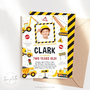 Puede incluir: Una invitación de cumpleaños con temática de construcción con un borde rayado amarillo y negro. La invitación presenta un espacio reservado para una foto, el nombre Clark y el texto "Stop the traffic. Close the road. Clark is turning two years old!" La invitación también incluye una fecha, hora y ubicación para la fiesta.