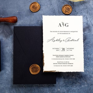 Custom black wedding invitation with gold foil, minimalist design, gilt foil frame, deckled edge, and a unique wax seal