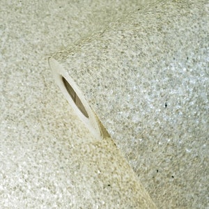 May include: A roll of white glitter wallpaper with a textured surface.
