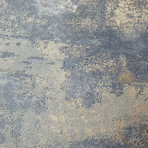 May include: A close-up of a textured surface with a blue and gold color scheme. The surface has a rough, uneven texture, with a subtle metallic sheen.