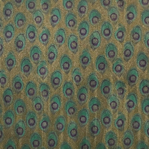 May include: A green and gold fabric with a repeating pattern of peacock feathers. The feathers are outlined in purple and have a textured appearance.
