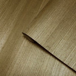 May include: Close-up of a gold textured wallpaper with a subtle sheen. The wallpaper has a woven look and feel.