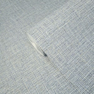 May include: A close-up of a roll of blue textured wallpaper with a subtle woven pattern.