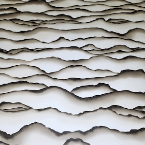 May include: Abstract art print featuring a layered design of black and white mountains. The mountains are layered on top of each other, creating a sense of depth and dimension.