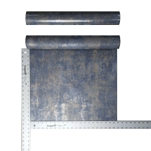 May include: A roll of blue and gold metallic wallpaper with a textured, distressed look. The wallpaper is rolled up and measured with a ruler.