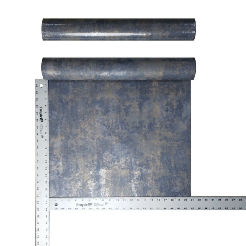 May include: A roll of blue and gold metallic wallpaper with a textured, distressed look. The wallpaper is rolled up and measured with a ruler.