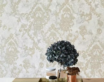 May include: A decorative tray with a gold finish holds a bouquet of blue flowers, three glass jars, and a copper cup. The jars contain dried herbs and the cup holds dried flowers. The tray is on a wood surface with a white and gold patterned wallpaper in the background.