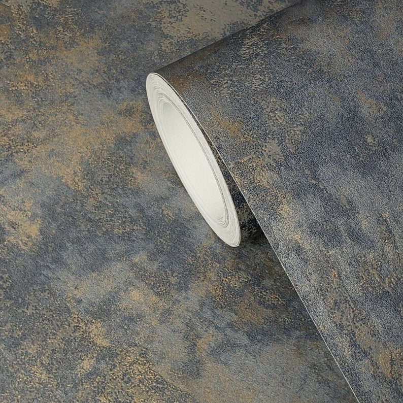 May include: A roll of dark blue and gold wallpaper with a textured, metallic finish. The wallpaper has a distressed look, with subtle hints of gold throughout.