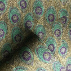 May include: Green and gold fabric with a peacock feather pattern. The fabric has a subtle shimmer.