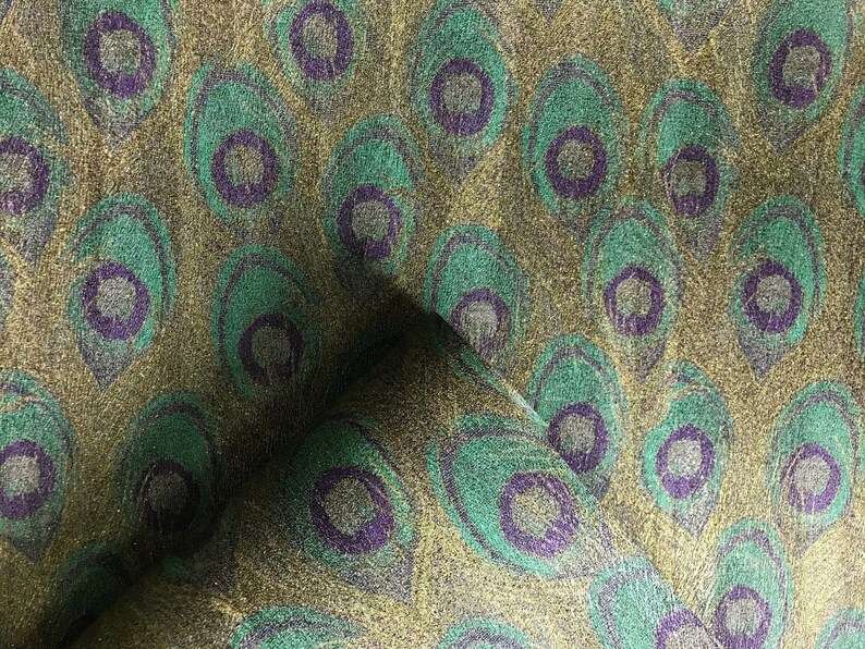 May include: Green and gold fabric with a peacock feather pattern. The fabric has a subtle shimmer.