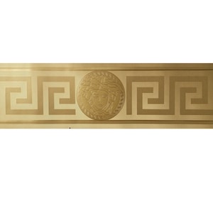 May include: Gold wallpaper border with a Greek key pattern and a circular design featuring a Medusa head.
