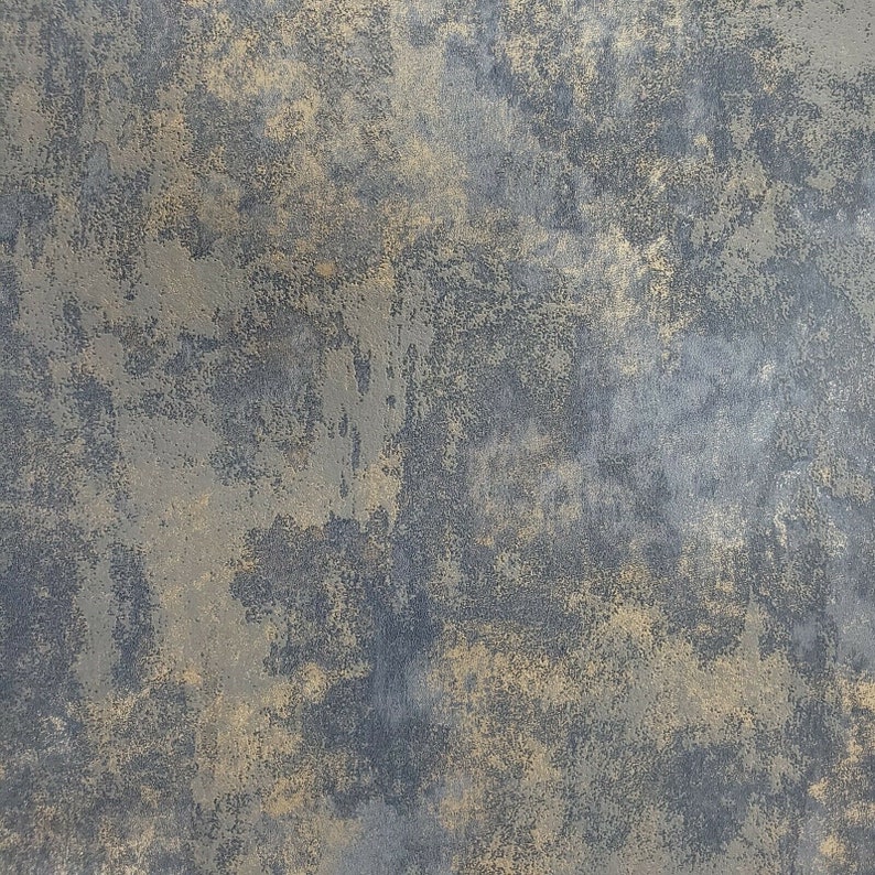 May include: A textured background with a dark gray and gold color scheme. The surface has a rough, uneven texture with a mottled appearance.