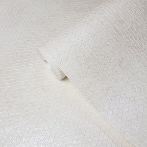 May include: White wallpaper with a textured geometric pattern of small triangles. The wallpaper is rolled up, showing the pattern from both the front and the back.