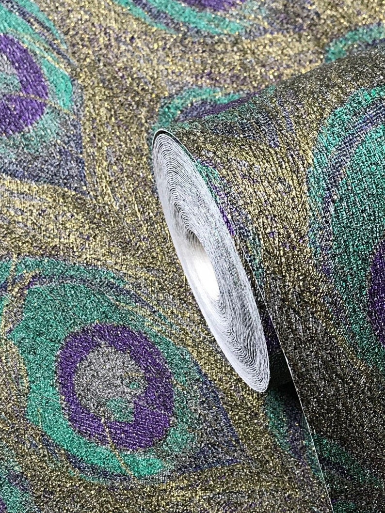 May include: A roll of gold, green, and purple patterned wallpaper with a glittery finish. The wallpaper features a peacock feather design.